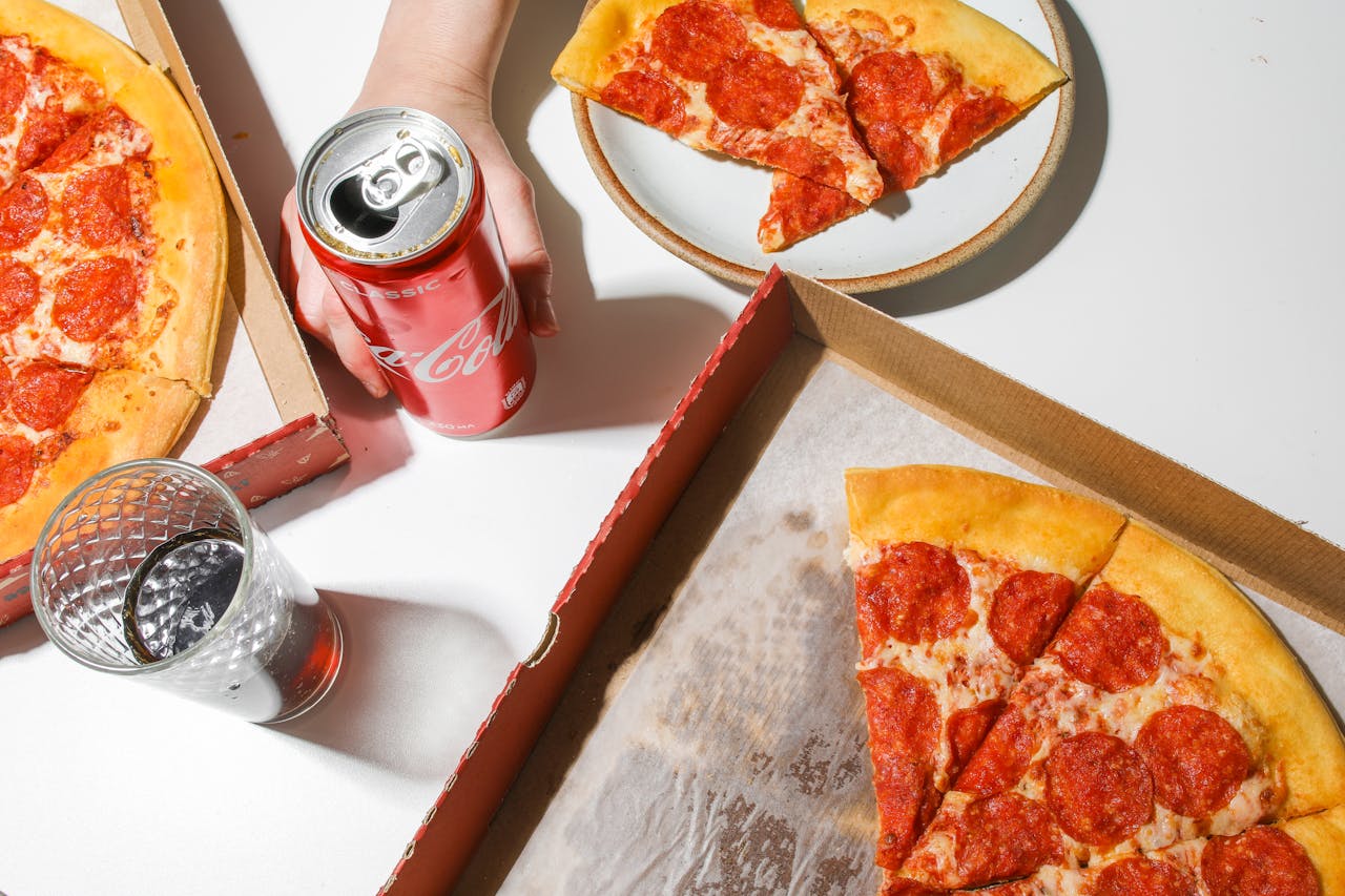 The Art of Drawing Readers In: Your attractive post title goes here Delicious pepperoni pizza with soda, ideal for fast food lovers.